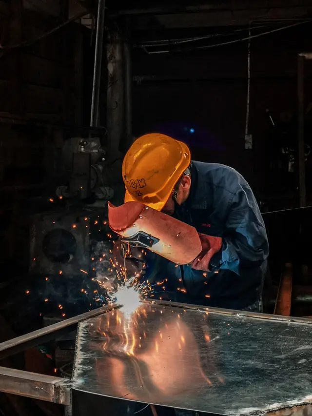 Man welding on gray